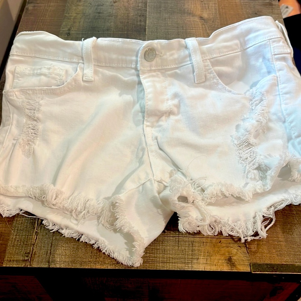 White jean shorts with rips